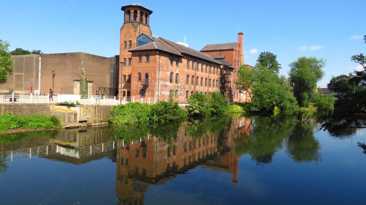 The red-brick Derby Silk Mill, home of the Museum of Making, reflected in the River Derwent