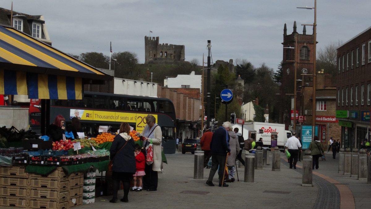 Market stalls on Dudley High Street, with the ruined keep of Dudley Castle on the hill behind