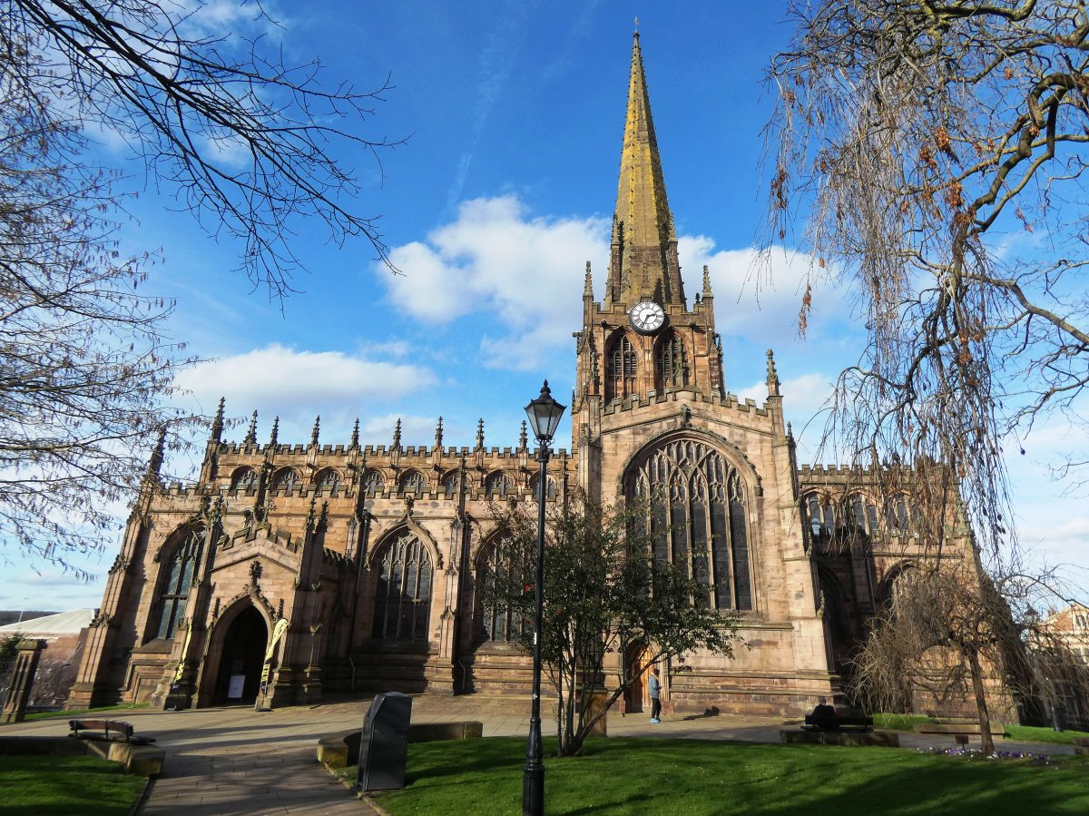 Rotherham Minster, a large sandstone church with a tall spire, under a blue sky