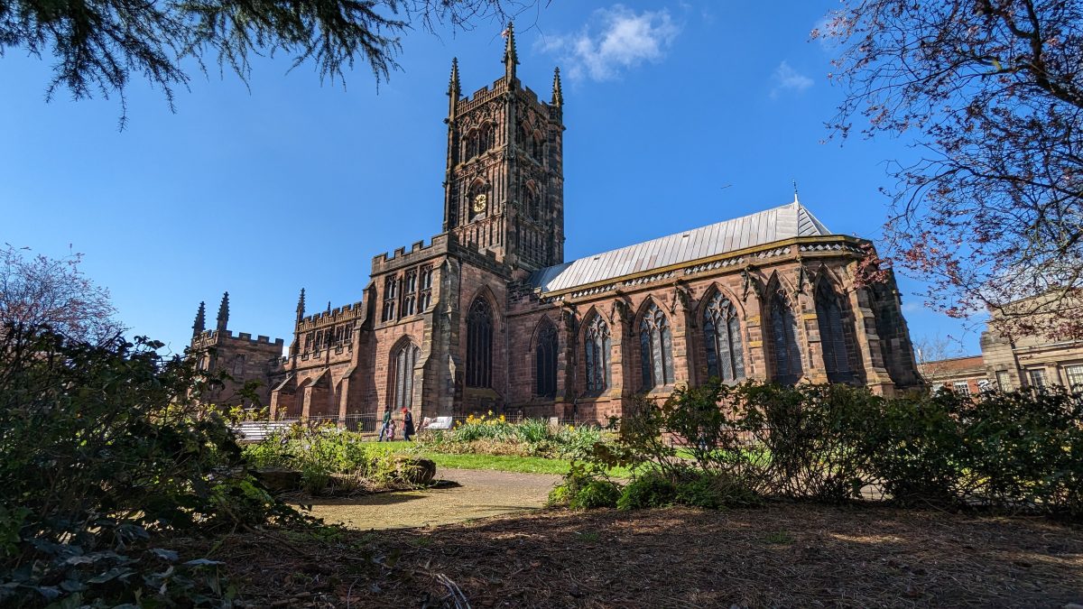 St Peter's Collegiate Church in Wolverhampton, a red sandstone church with a tall tower, under a clear blue sky